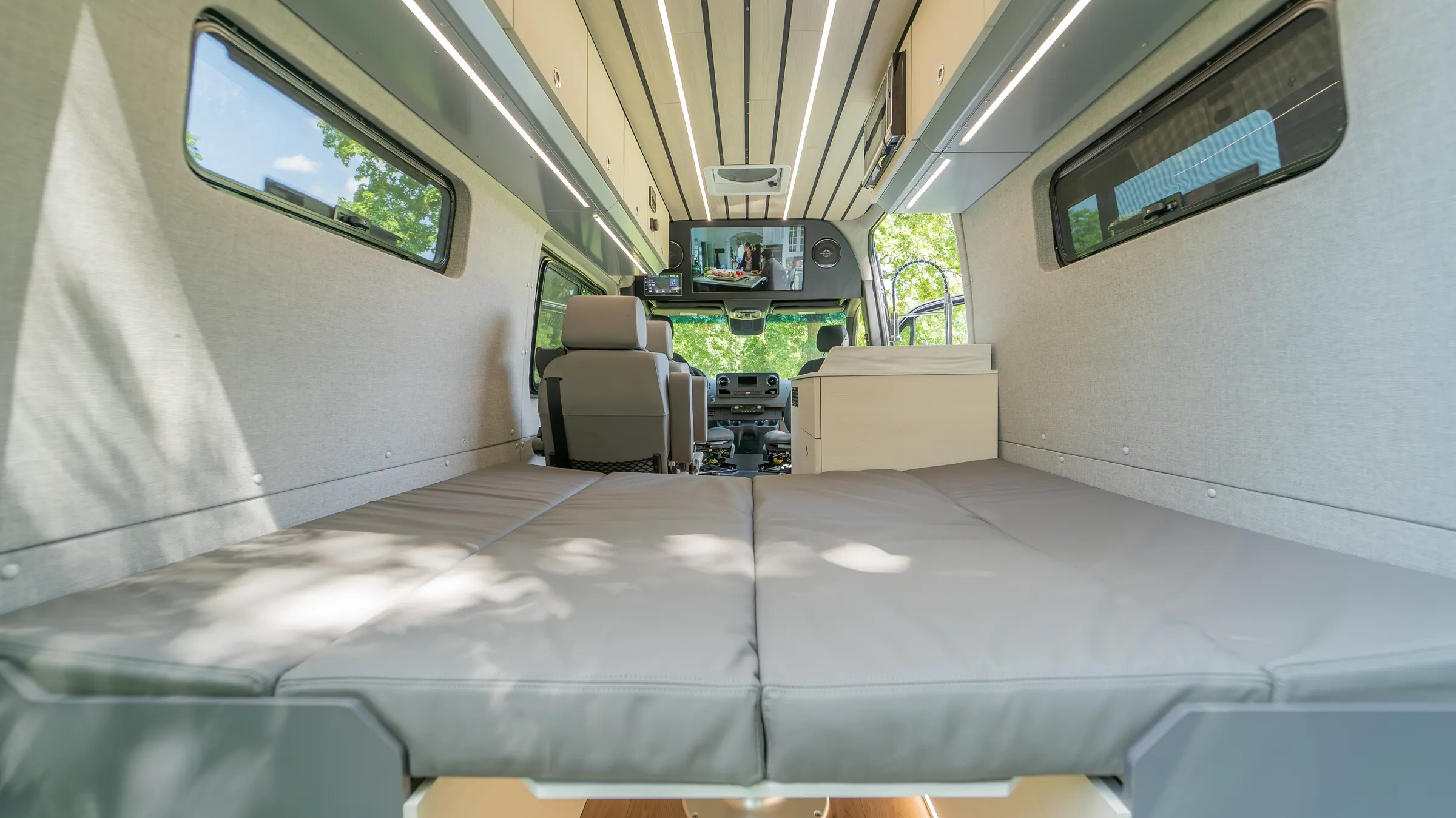 The same dinette made up as a bed, the cushions laid flat across the full width of the cabin