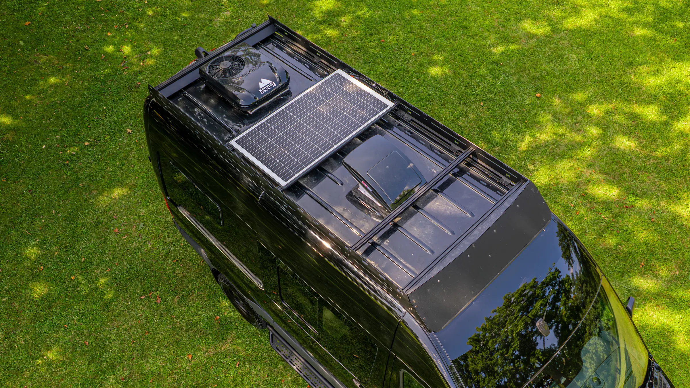Overhead view of the roof rack, carrying the solar panel, the roof fan and the hatch