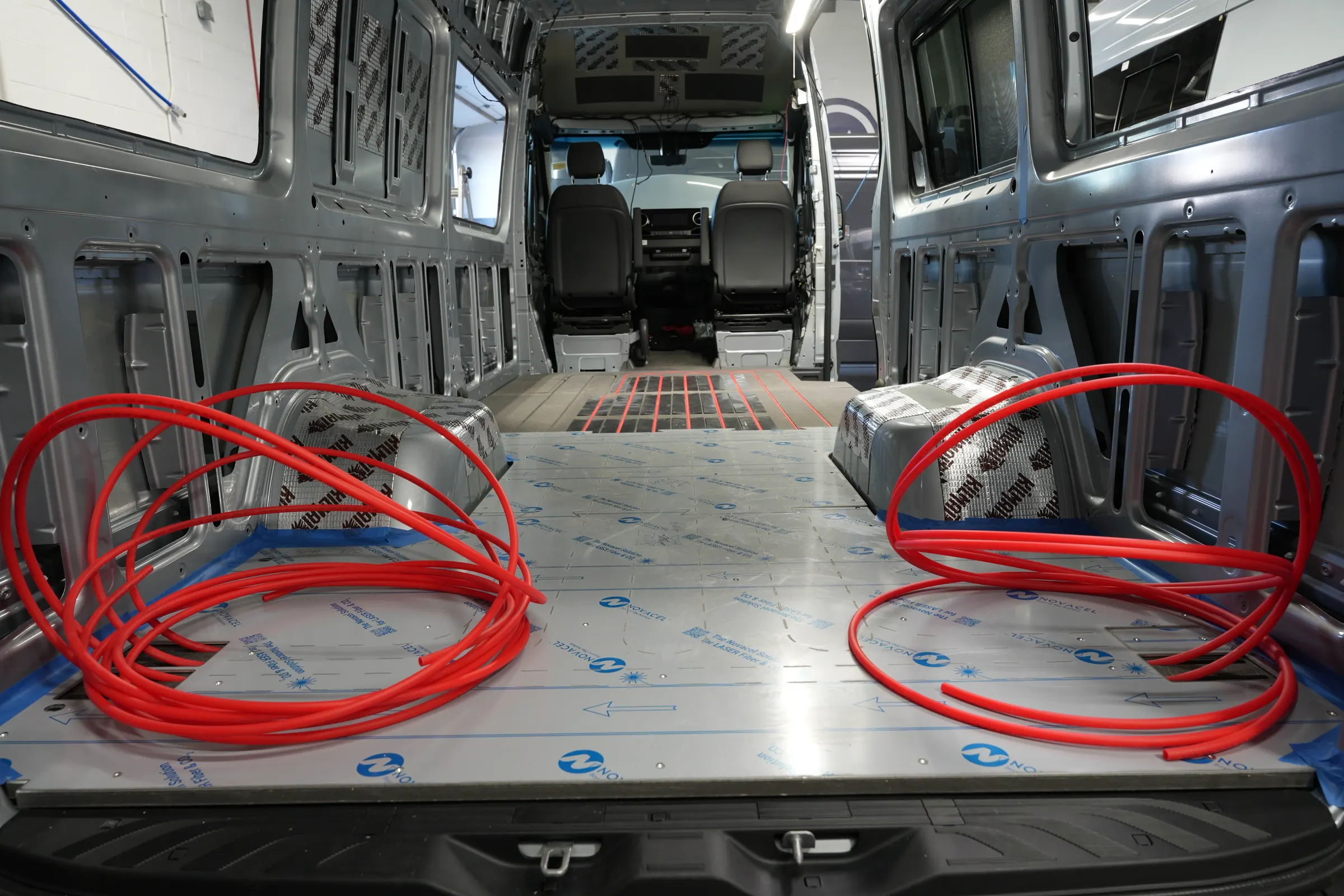 Hydronic radiant floor heating tubes installed in a custom 4-season camper van