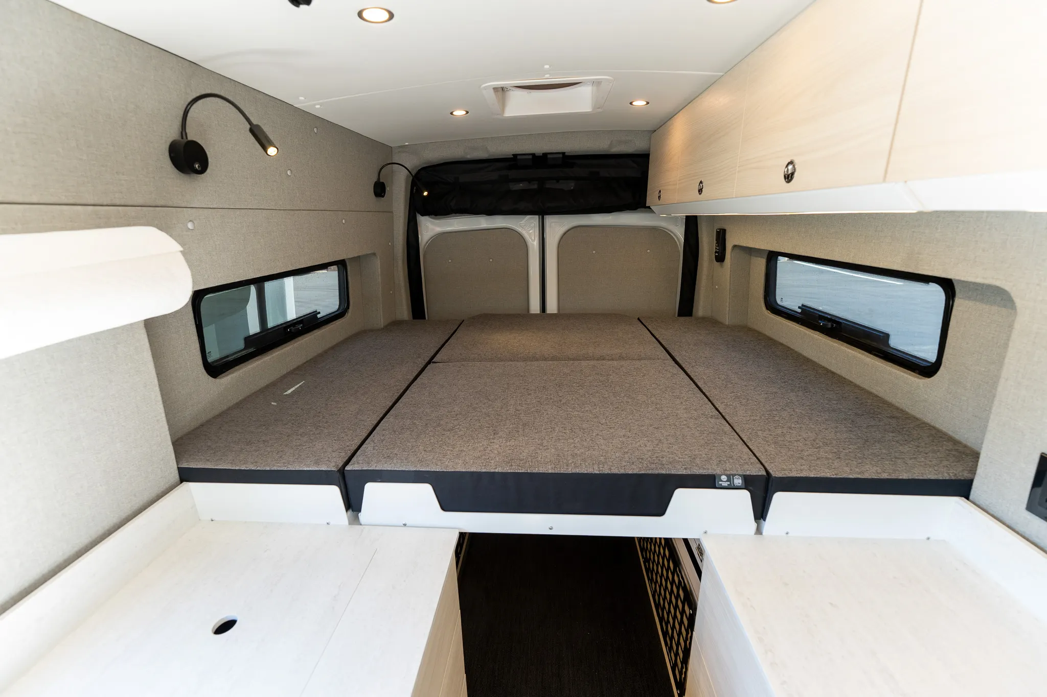 The bed made up, looking to the rear doors
