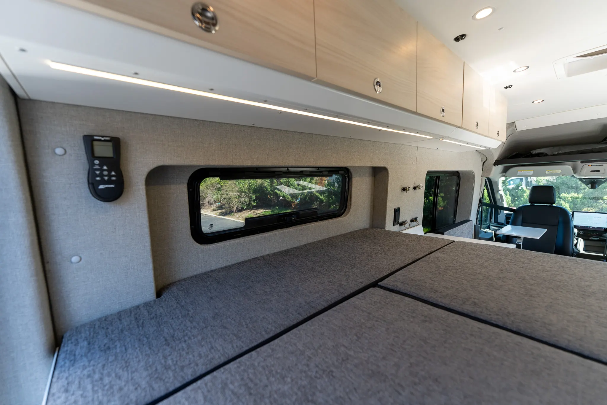 The bed made up across the rear, looking forward to the cab