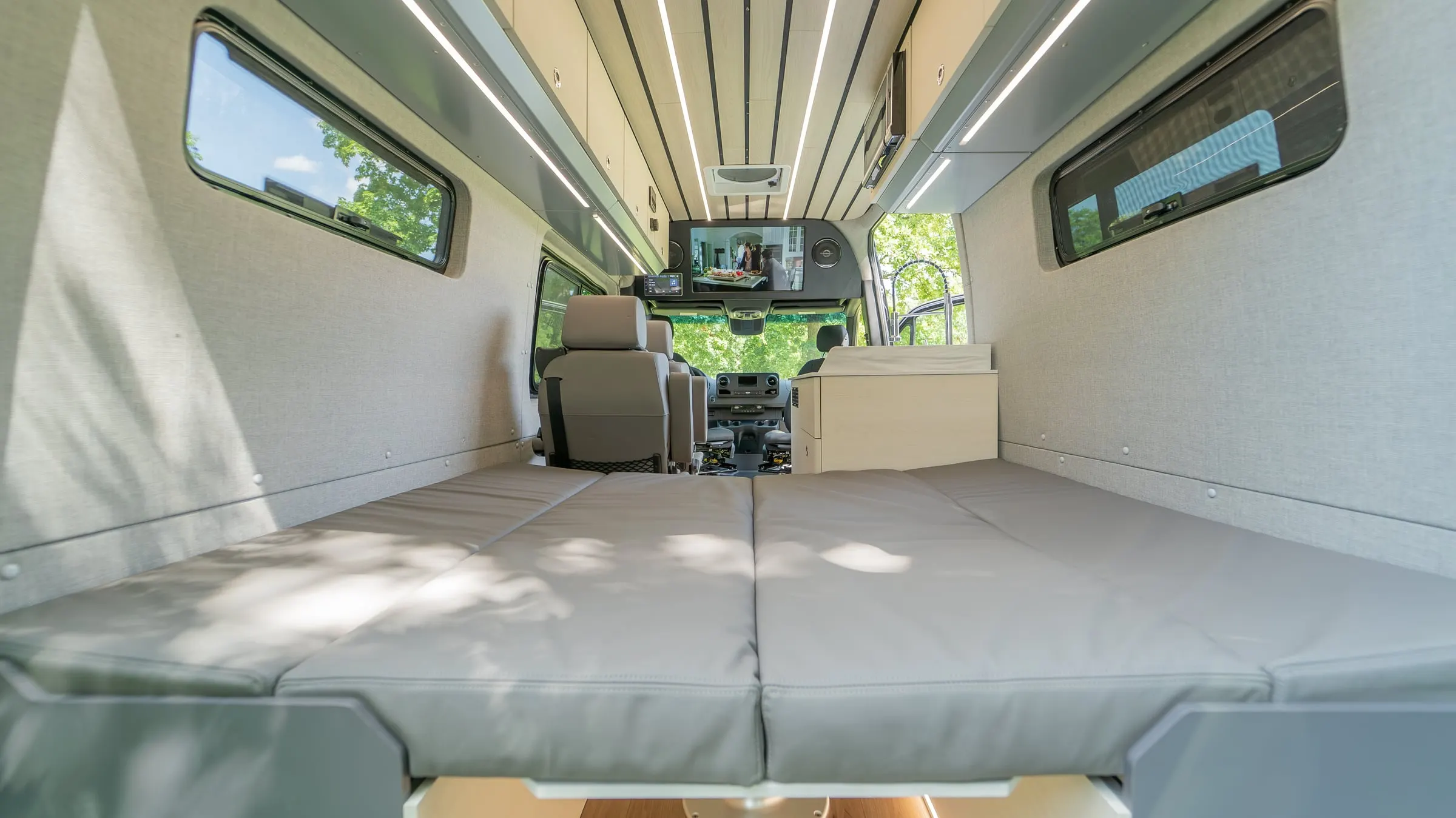 The same dinette made up as a bed, the cushions laid flat across the full width of the cabin