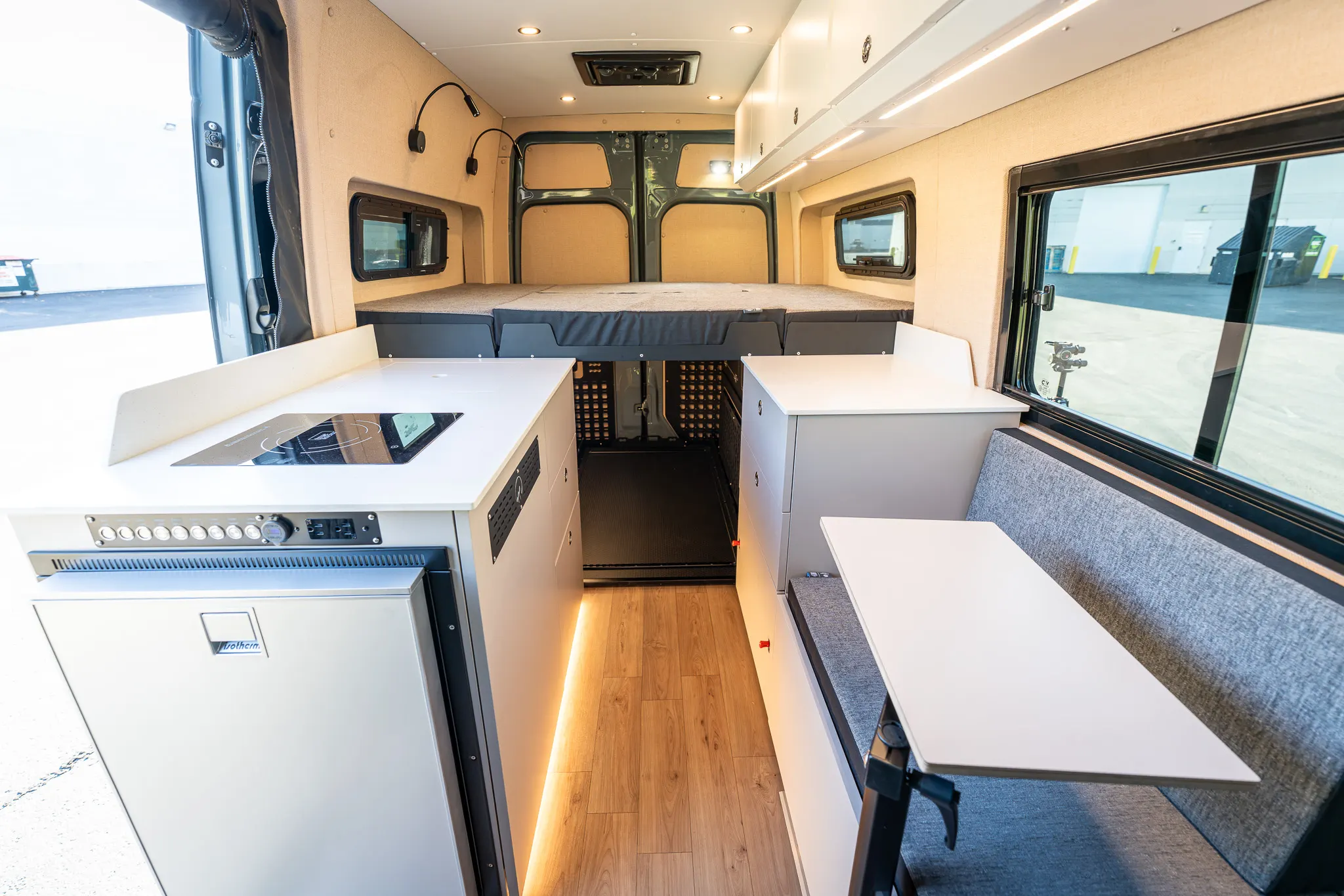The kitchen and the folded bed, looking to the rear from the cab