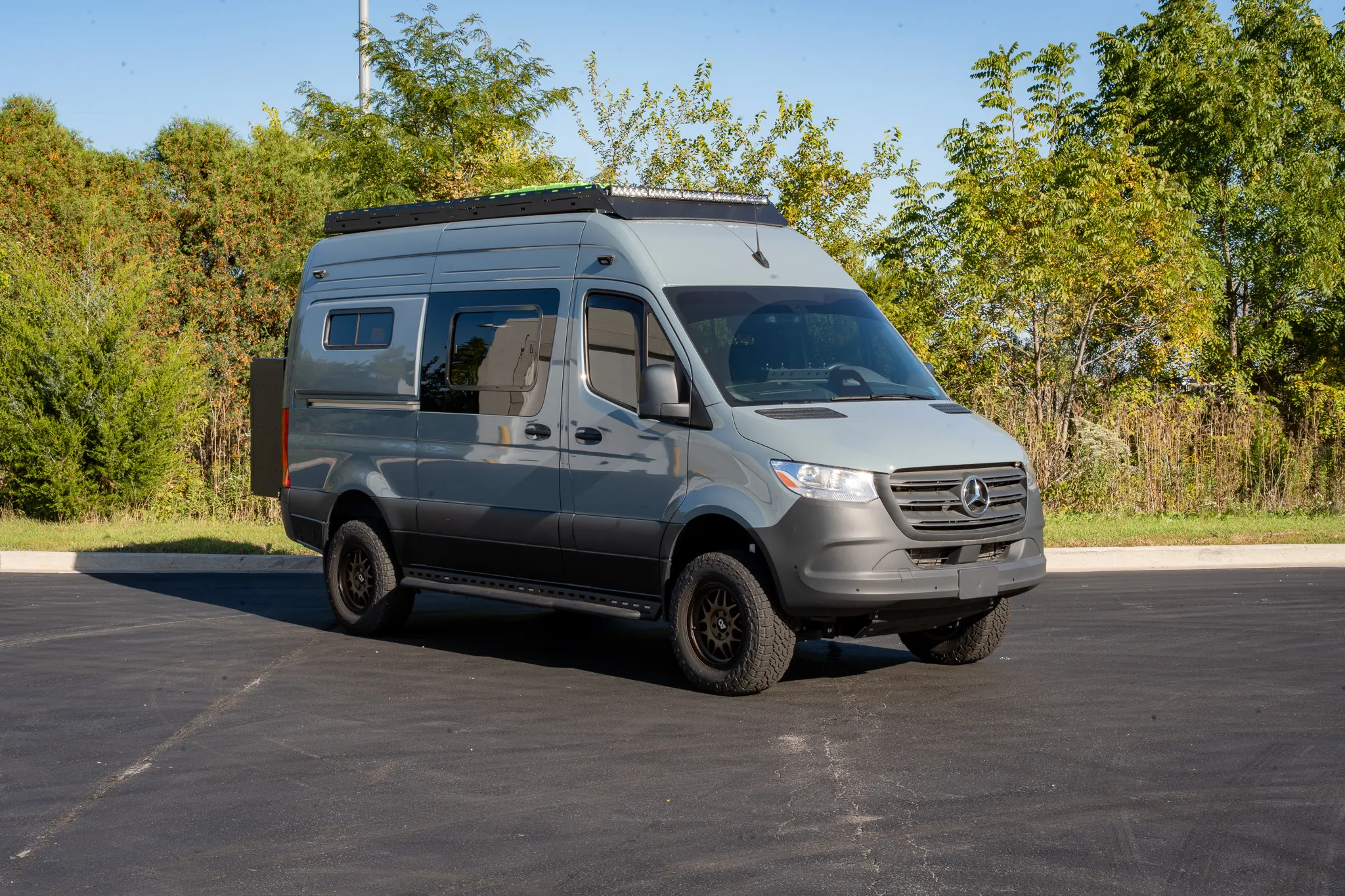 The Blue Grey Sprinter from the front, three-quarter view from the passenger side, on bronze wheels