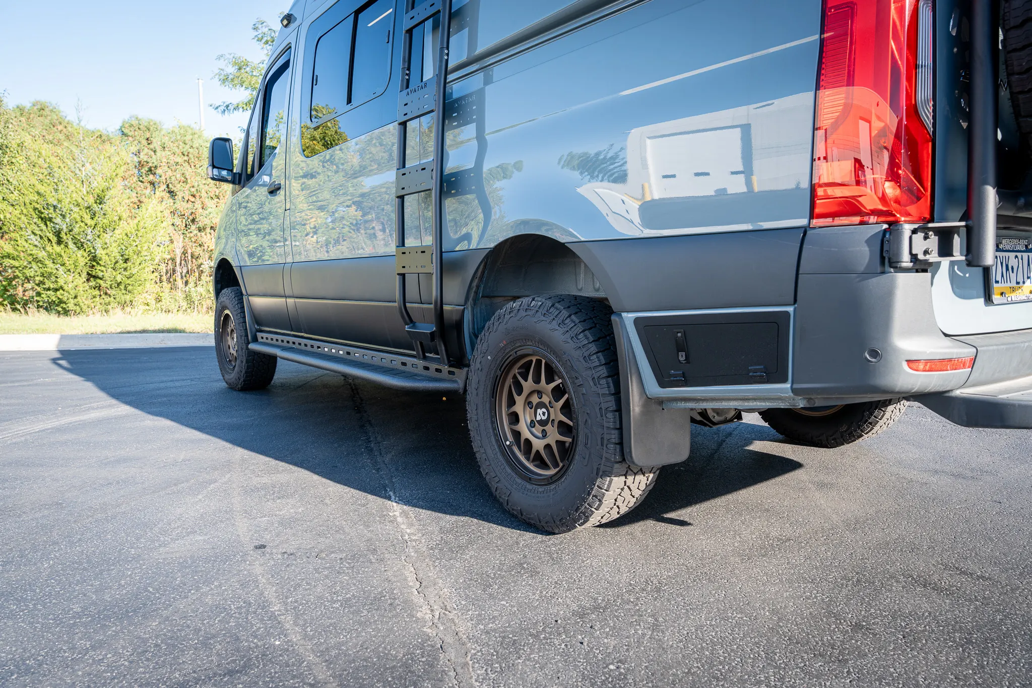 The driver side from the rear, on all-terrain tires