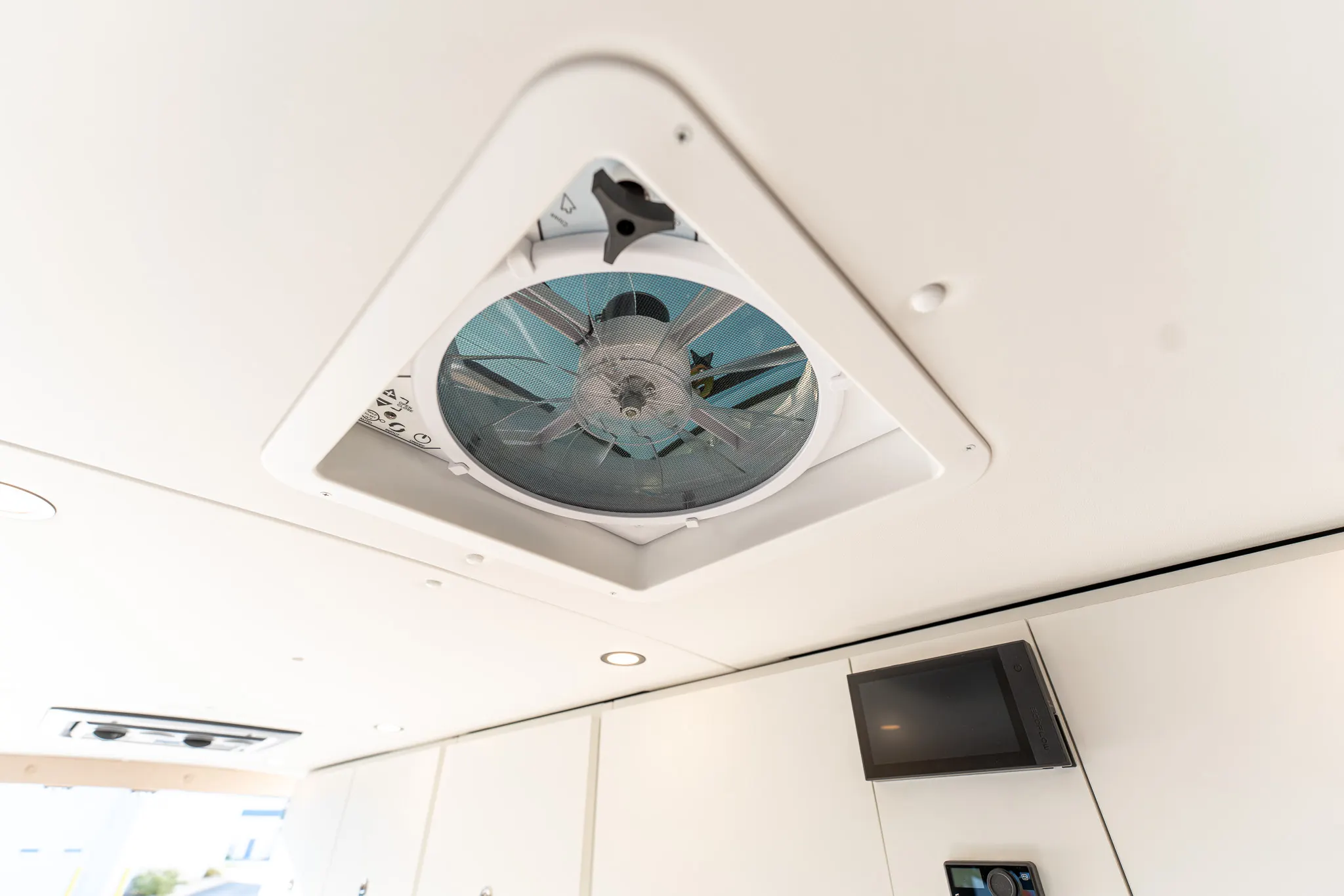 The roof fan and the control screen in the overhead cabinet